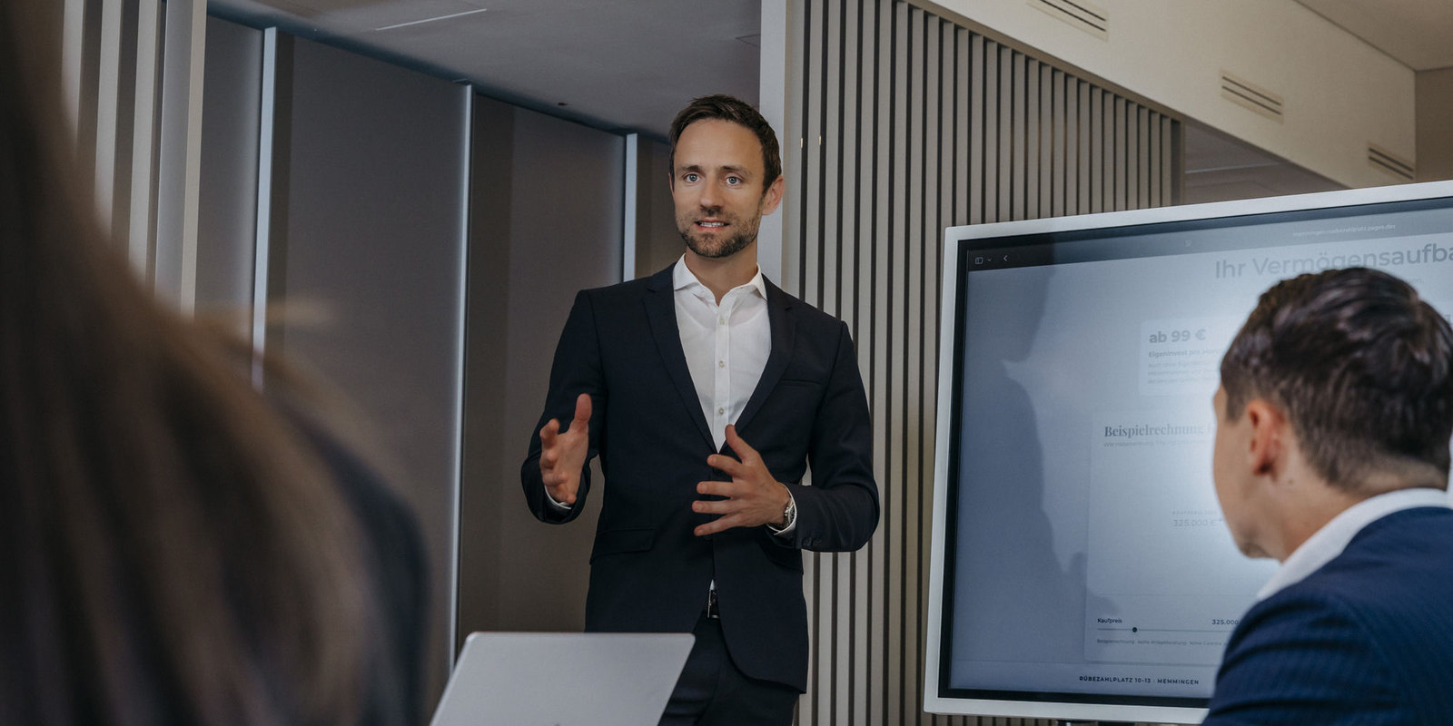A NeoCore advisor walking clients through an investment plan in the office